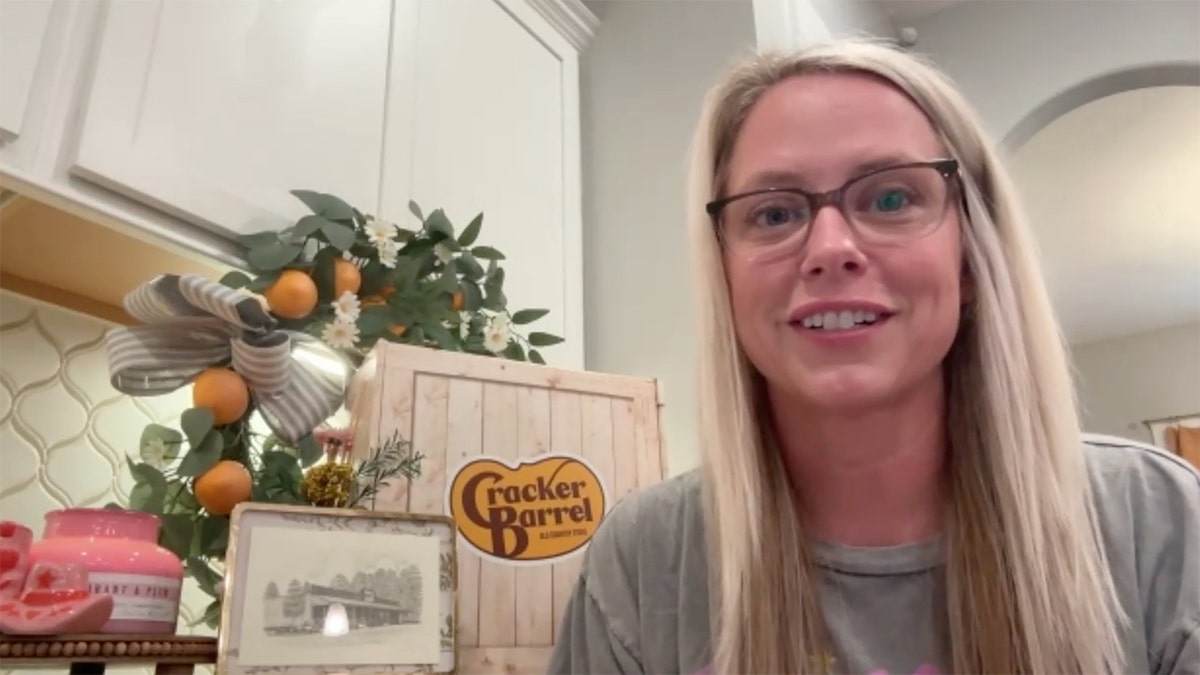 Rachel Love stands next to a Cracker Barrel display