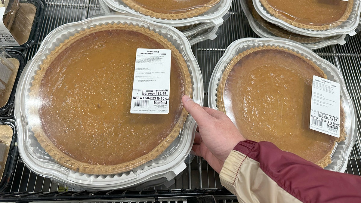 Shoppers with giant pumpkin pies at Costco