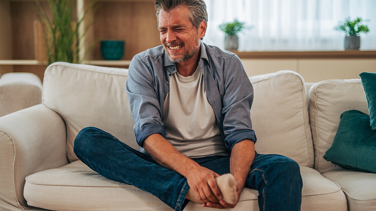 Man with gout foot pain