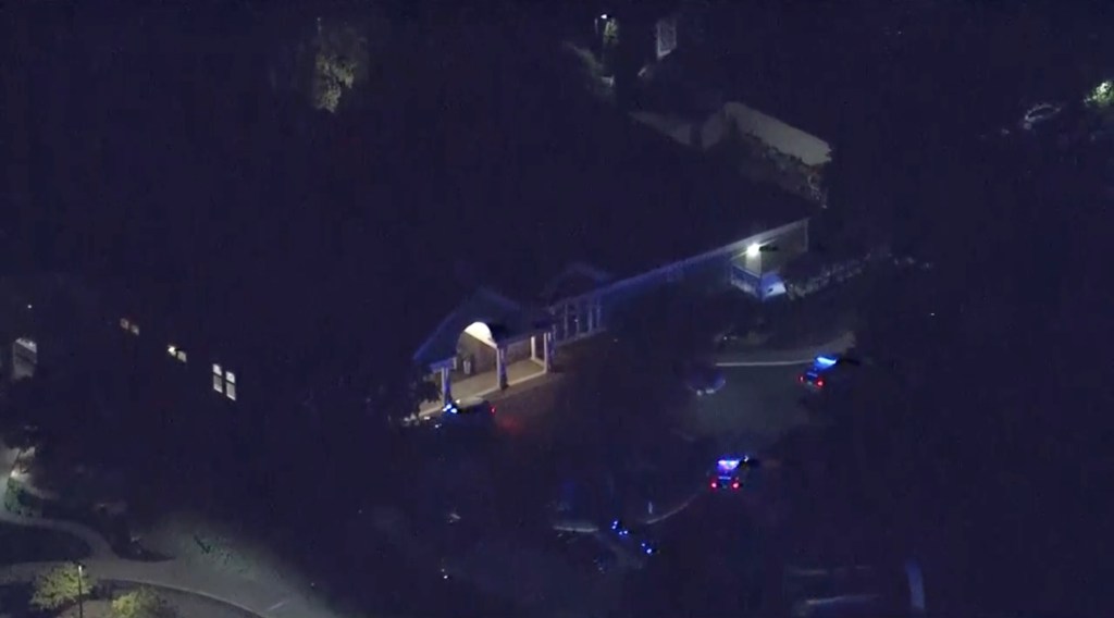 Ambulances lined up outside a hotel used as a reunification center