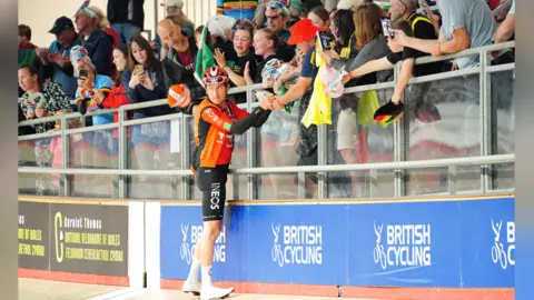 Young fans and riders at the start of the final stage