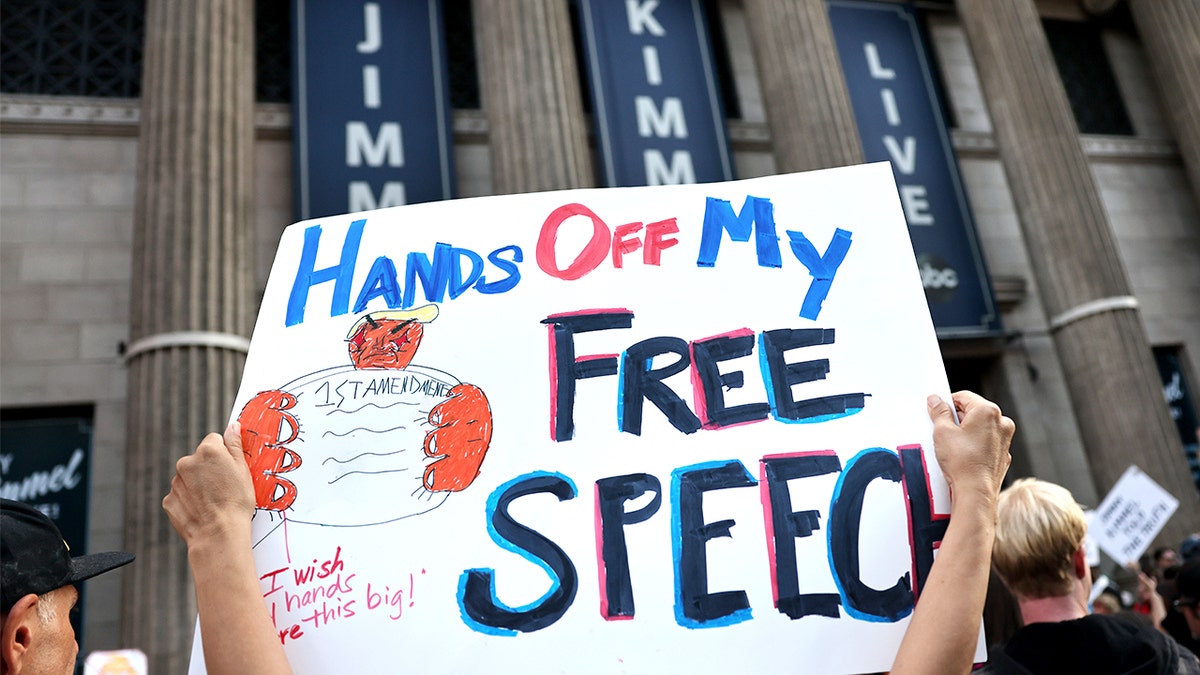 Image featuring Kimmel during a public protest and media coverage