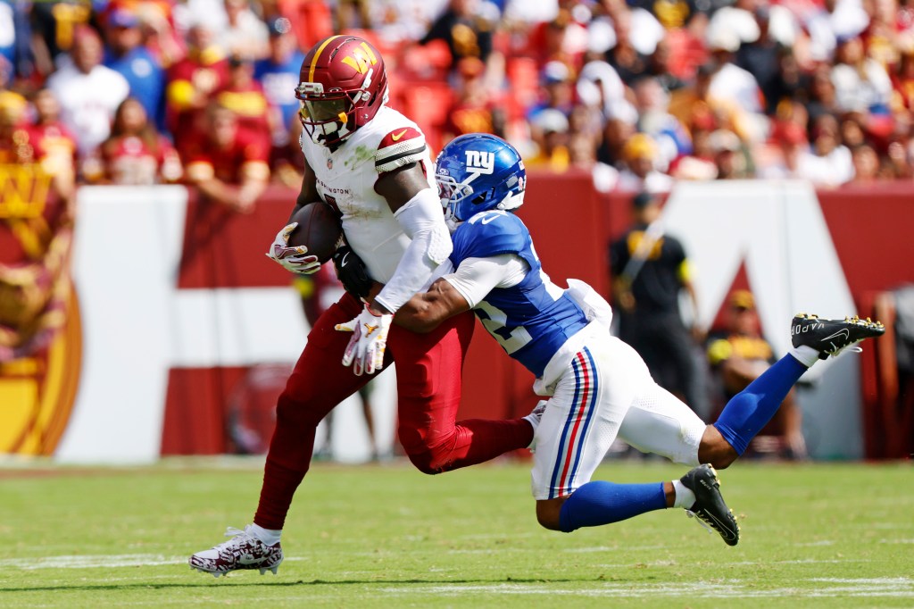 Deebo Samuel tries to avoid a tackle during his Commanders debut