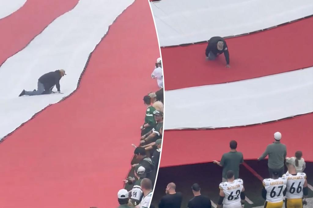 Fan Crawls Across Giant American Flag During National Anthem at Jets-Steelers Opener