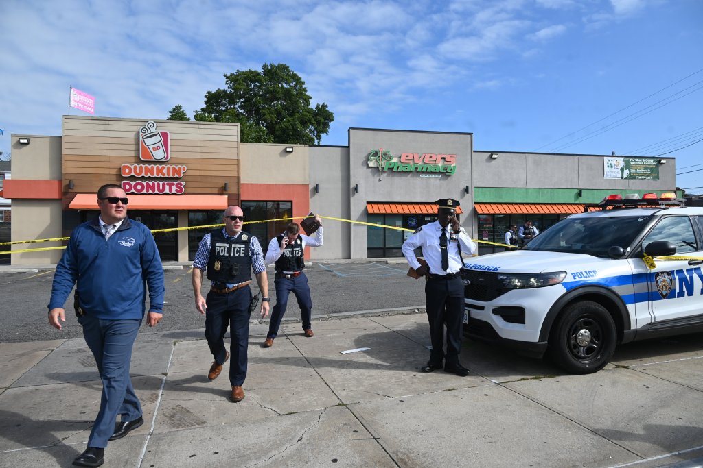 Police tape and investigators at the scene