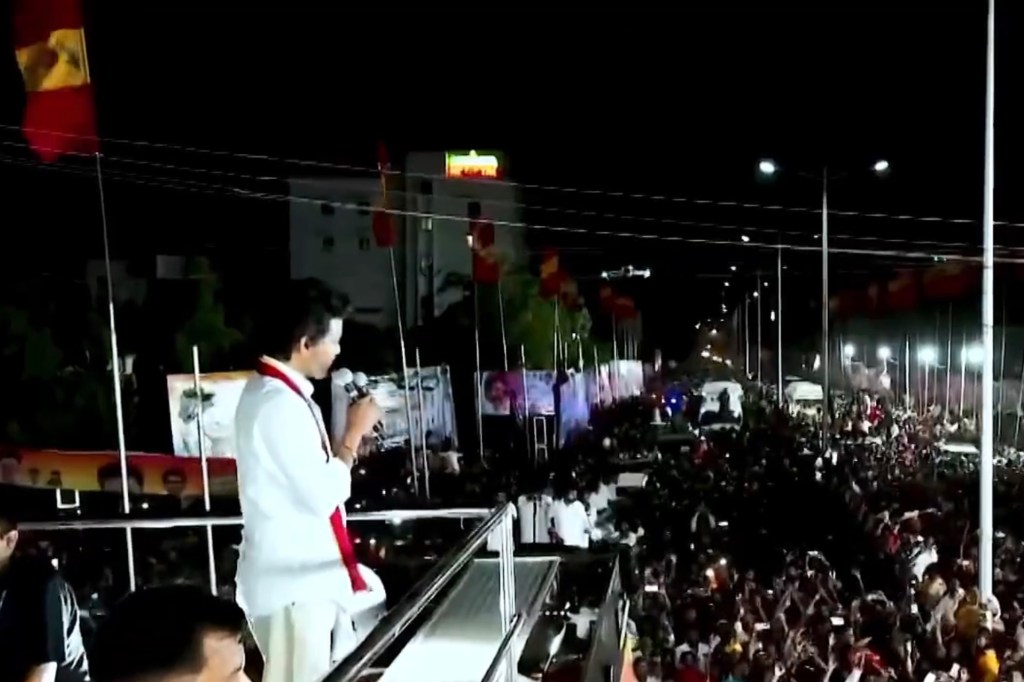 Vijay addressing crowd from atop his campaign vehicle