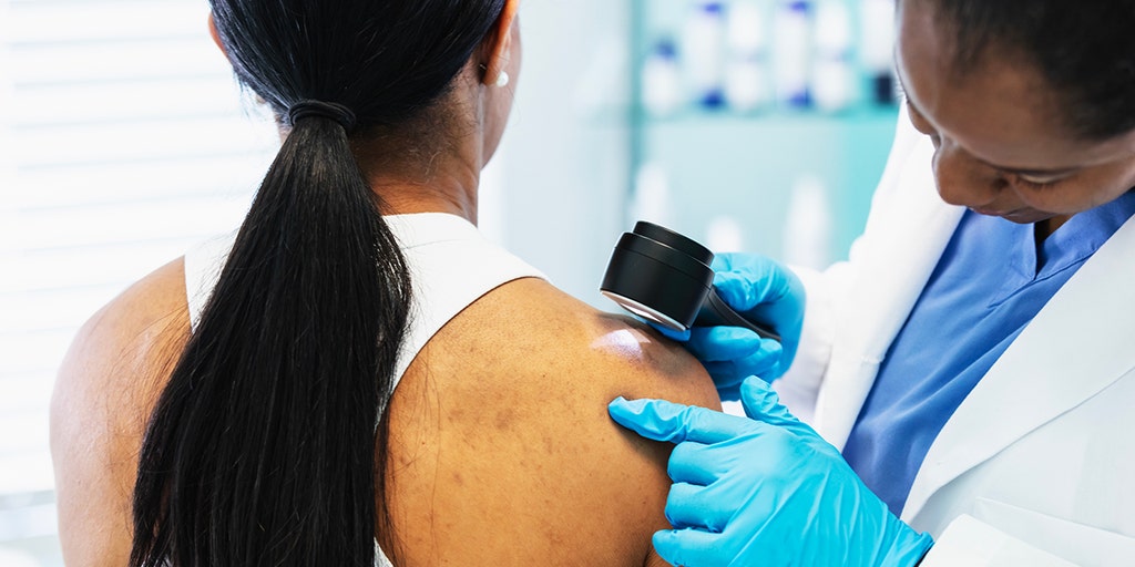 Dermatologist with patient