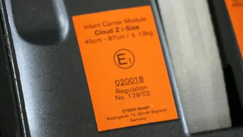 Close-up of an approval label on a child car seat