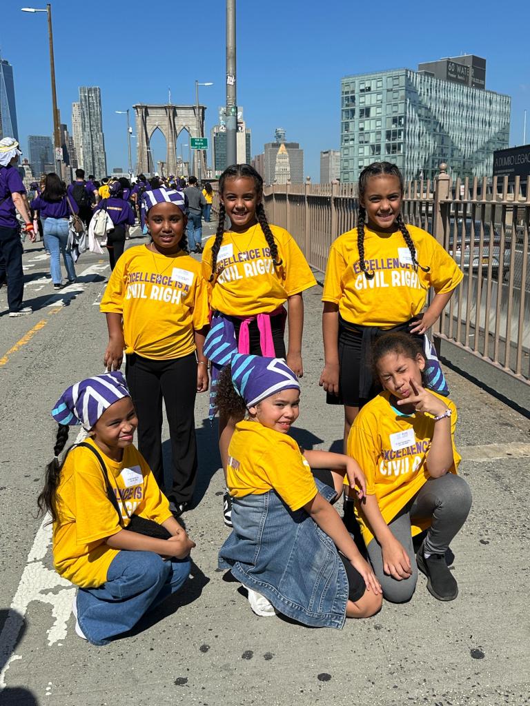 Children carrying signs at a charter school rally