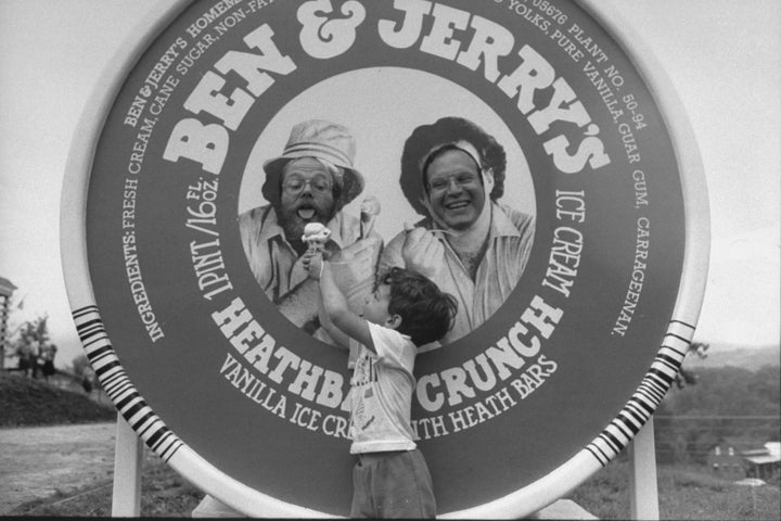 Ben & Jerry's co‑founders share an ice cream cone at a company event