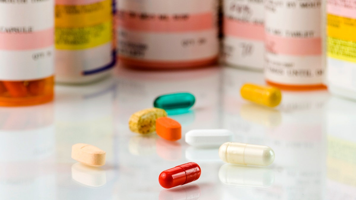 Prescription pills on a wooden surface
