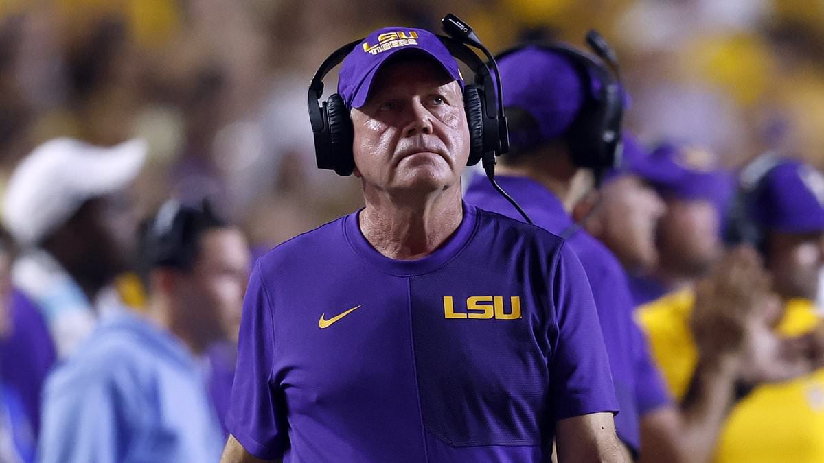 LSU coach Brian Kelly knocked to the ground after collision with own player on sideline