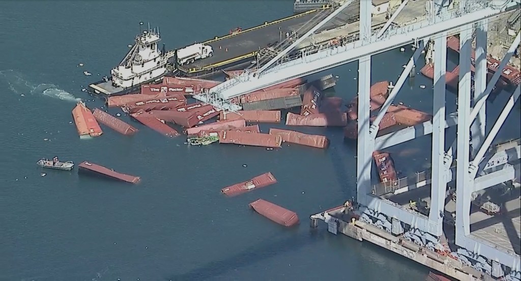 Dozens of fallen shipping containers next to the Portugal-registered ship Mississippi Madera