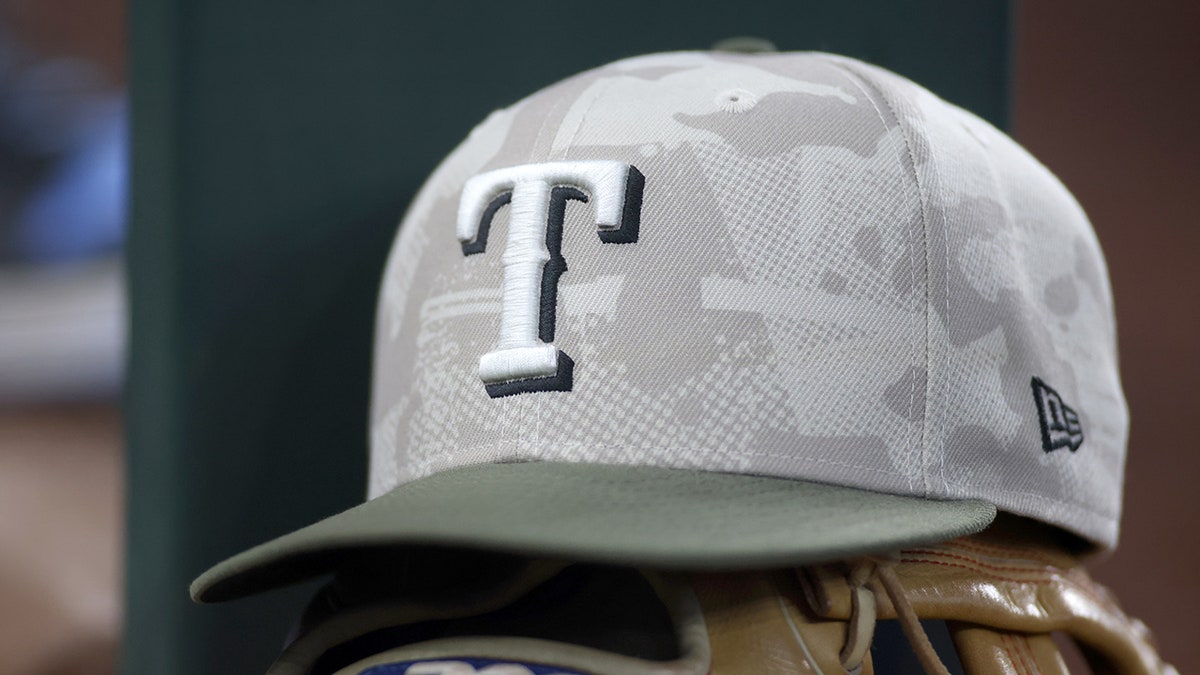 Texas Rangers hat and glove in dugout 3