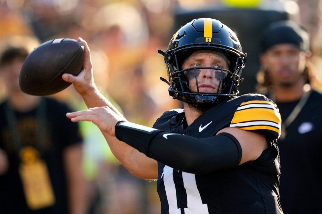 Iowa quarterback Mark Gronowski warms