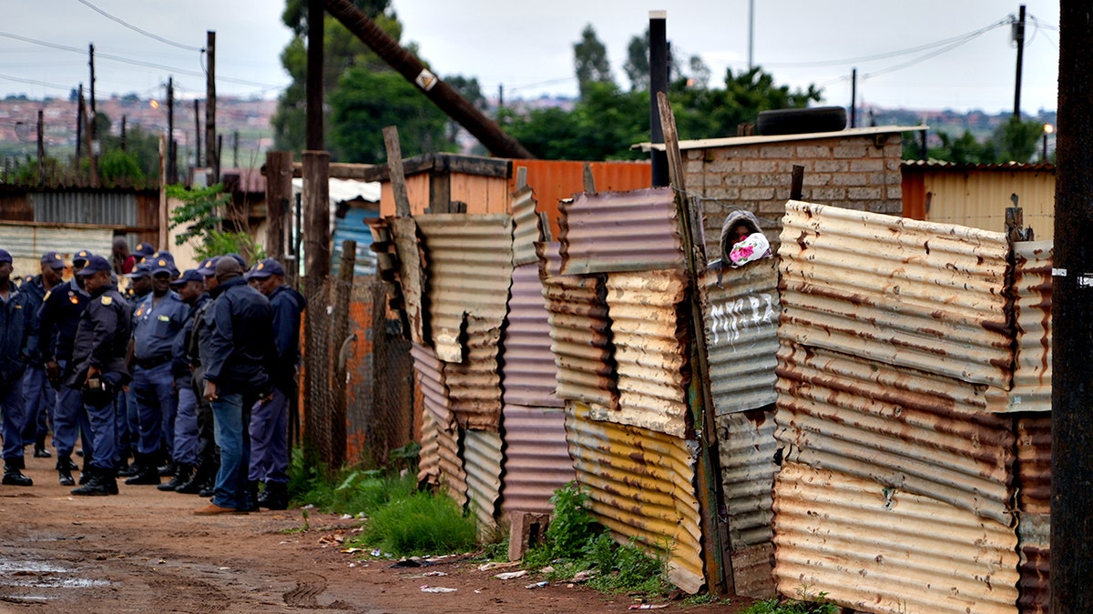 Police secure the scene near the Bekkersdal tavern