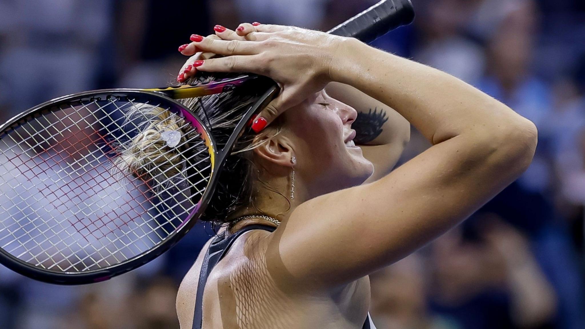 Sabalenka kneeling after victory