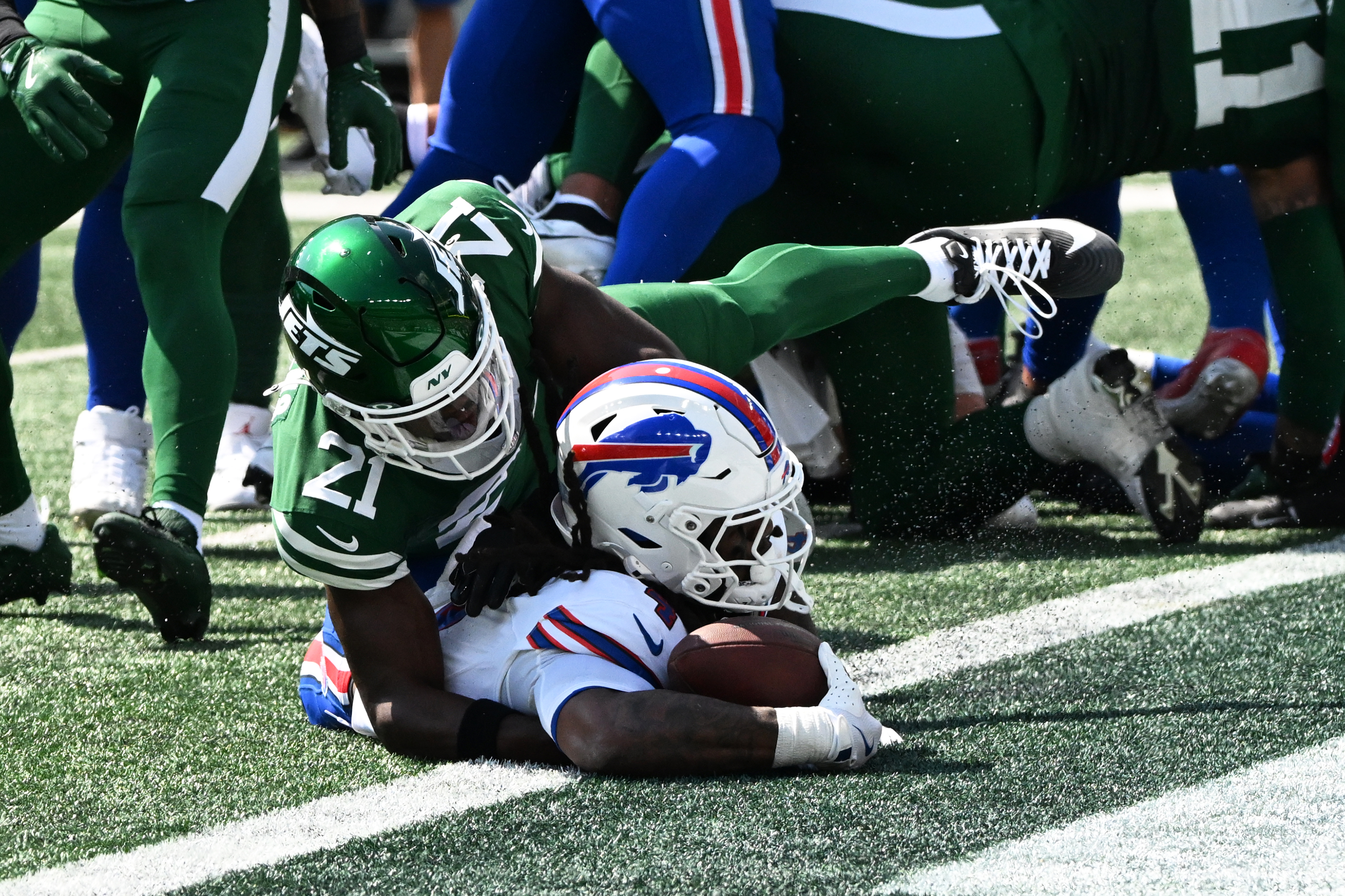 Jets defenders attempt to stop Cook in the end zone