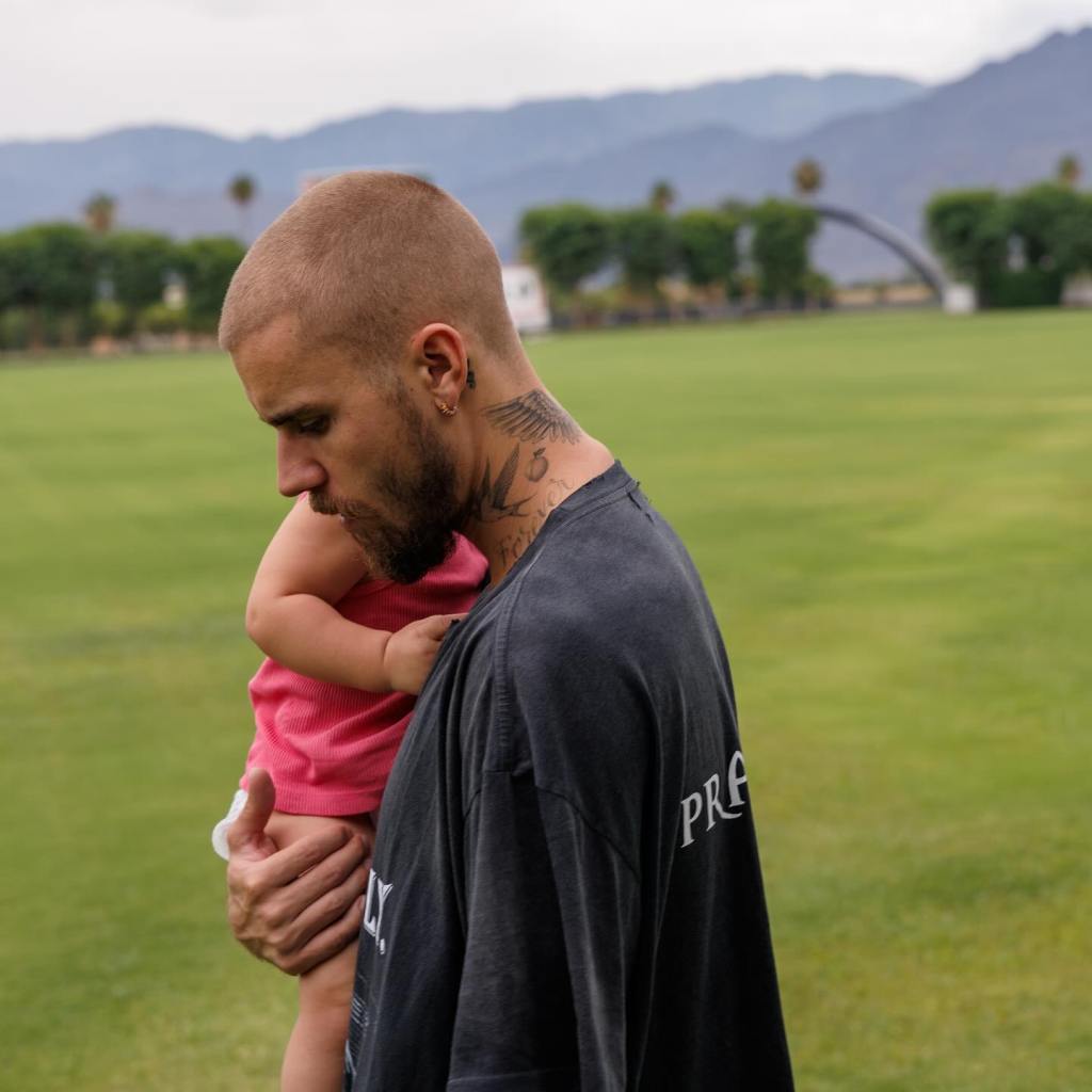 Hailey Bieber holds Jack Blues at Coachella