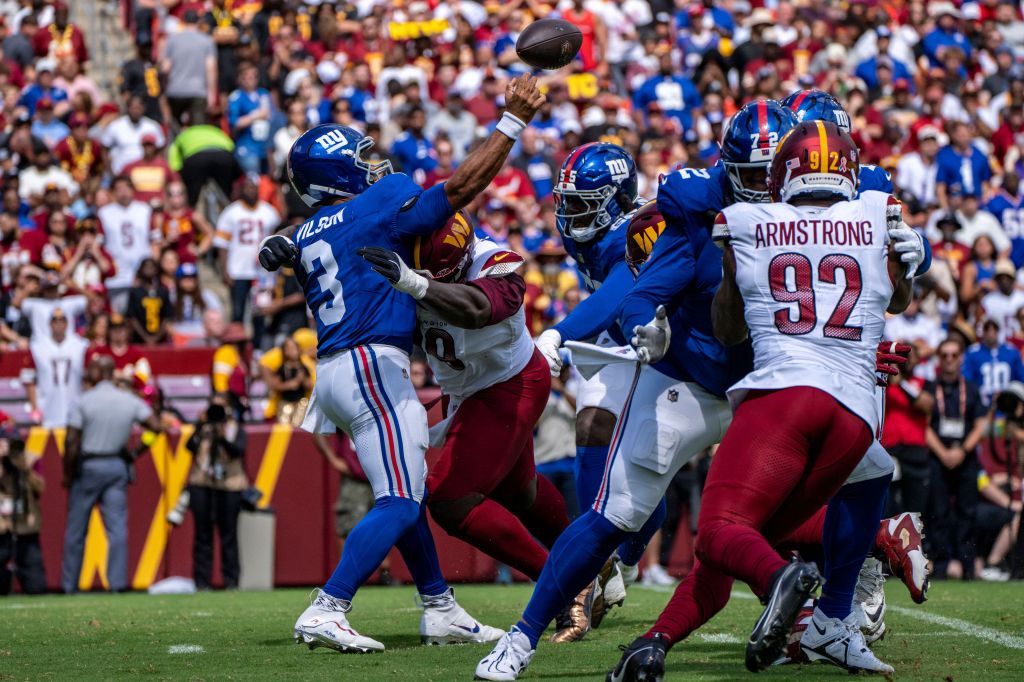 Wilson is taken down by the Commanders' pass rush