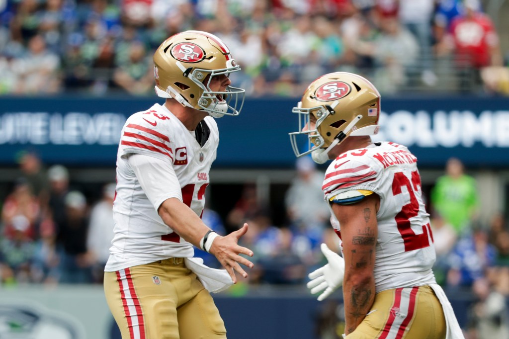 Brock Purdy celebrates a touchdown against the Seahawks