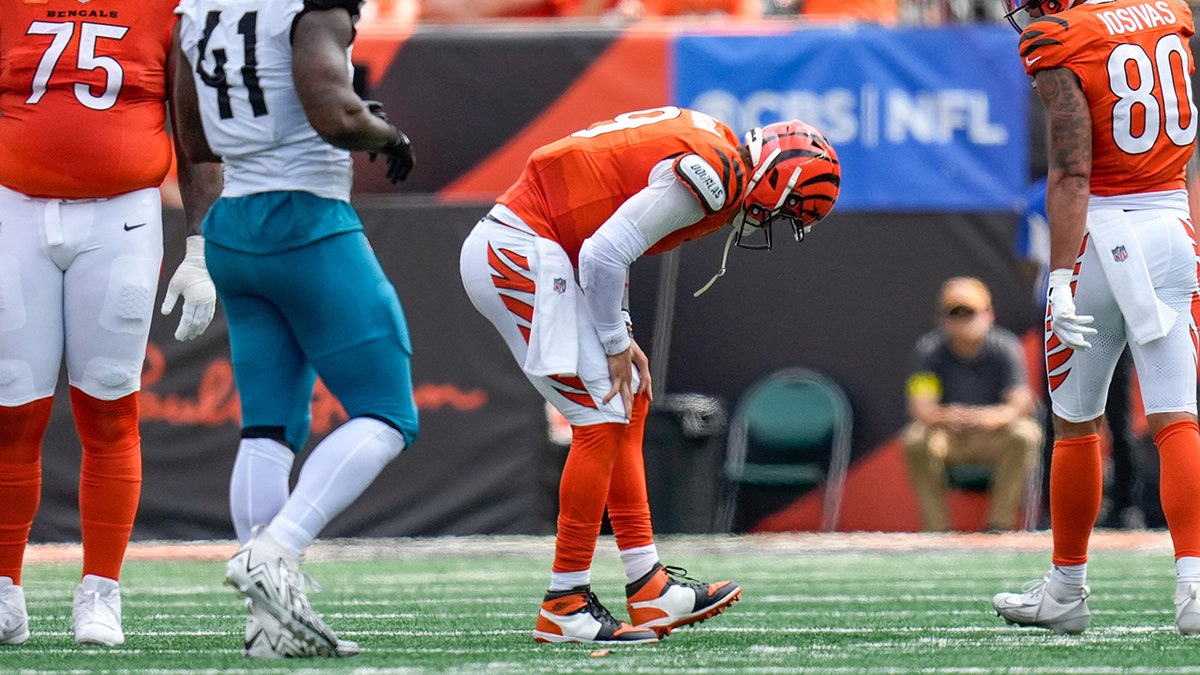 Burrow crouching on the field before the injury