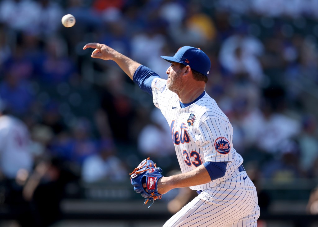 R.A. Dickey walks on the field before the Alumni Classic
