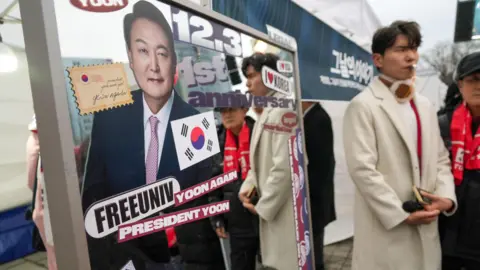 A sign reading 'Korea for Koreans' at a rally