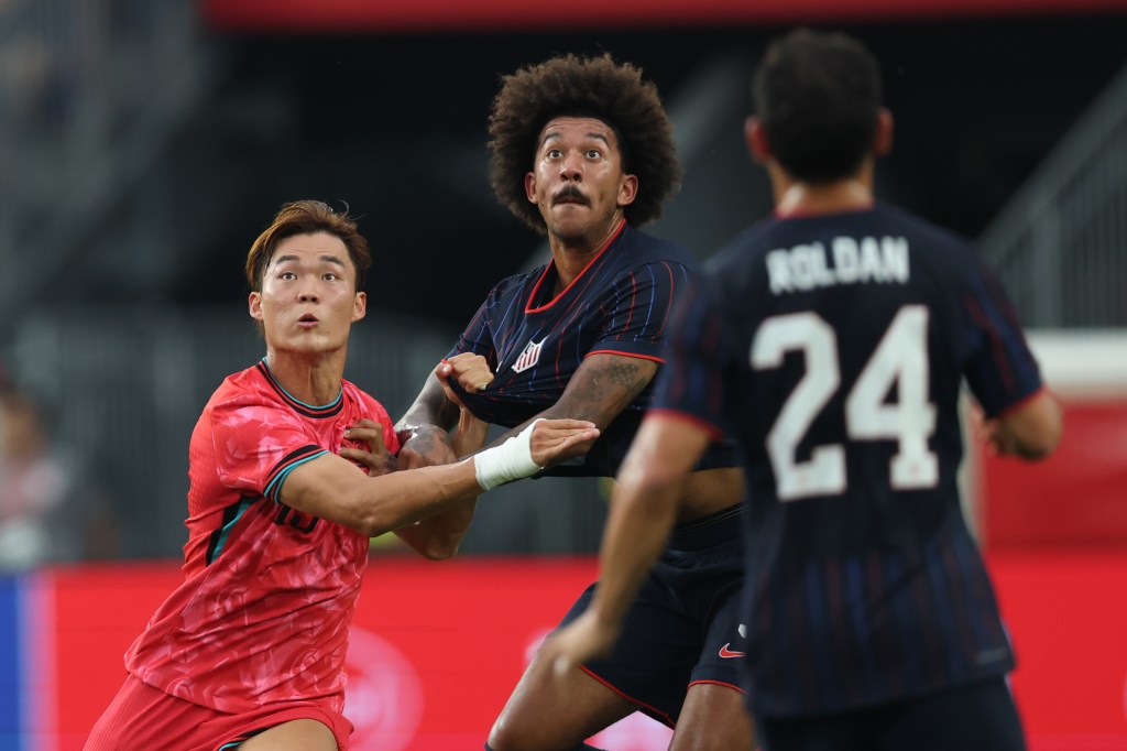 Chris Richards contests a ball against South Korea