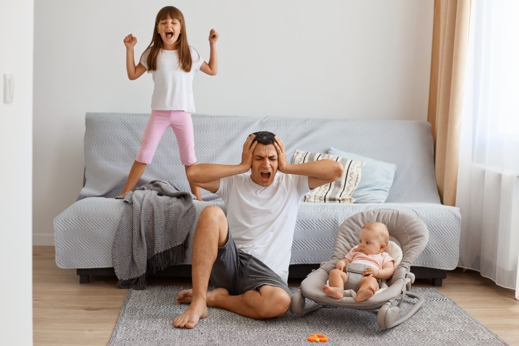 Tired, hands-on-hips father