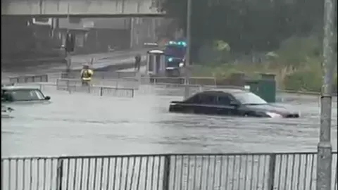 Torrential Rain Submerges Cars at Swansea Roundabout as Flood Warnings Issued