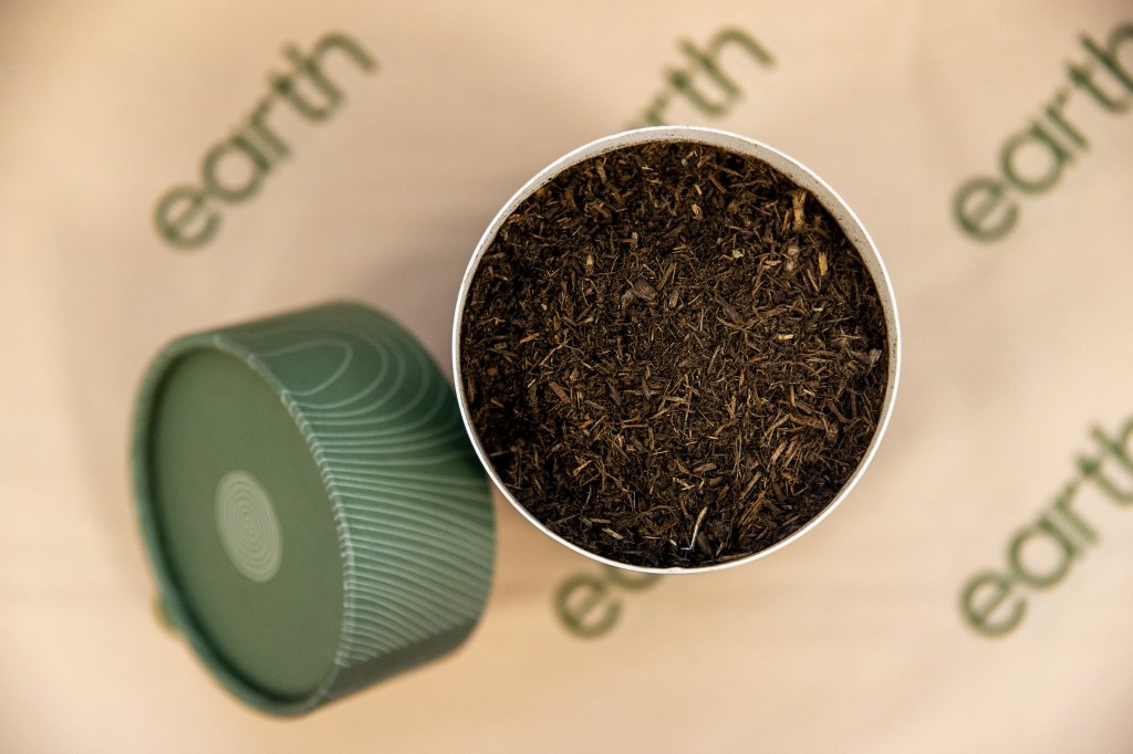 Staff monitor composting vessels during the natural organic reduction process