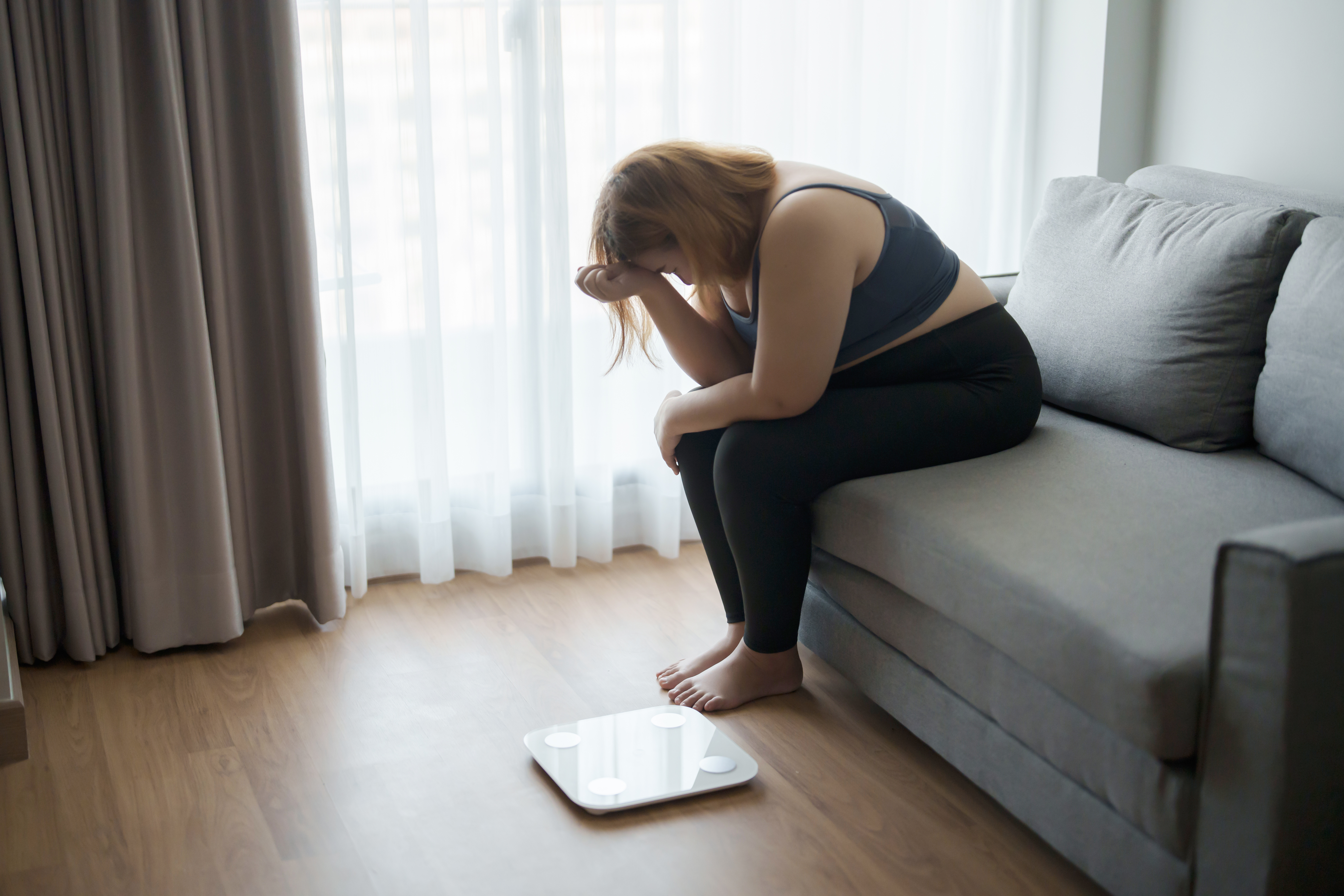Overweight woman looking down