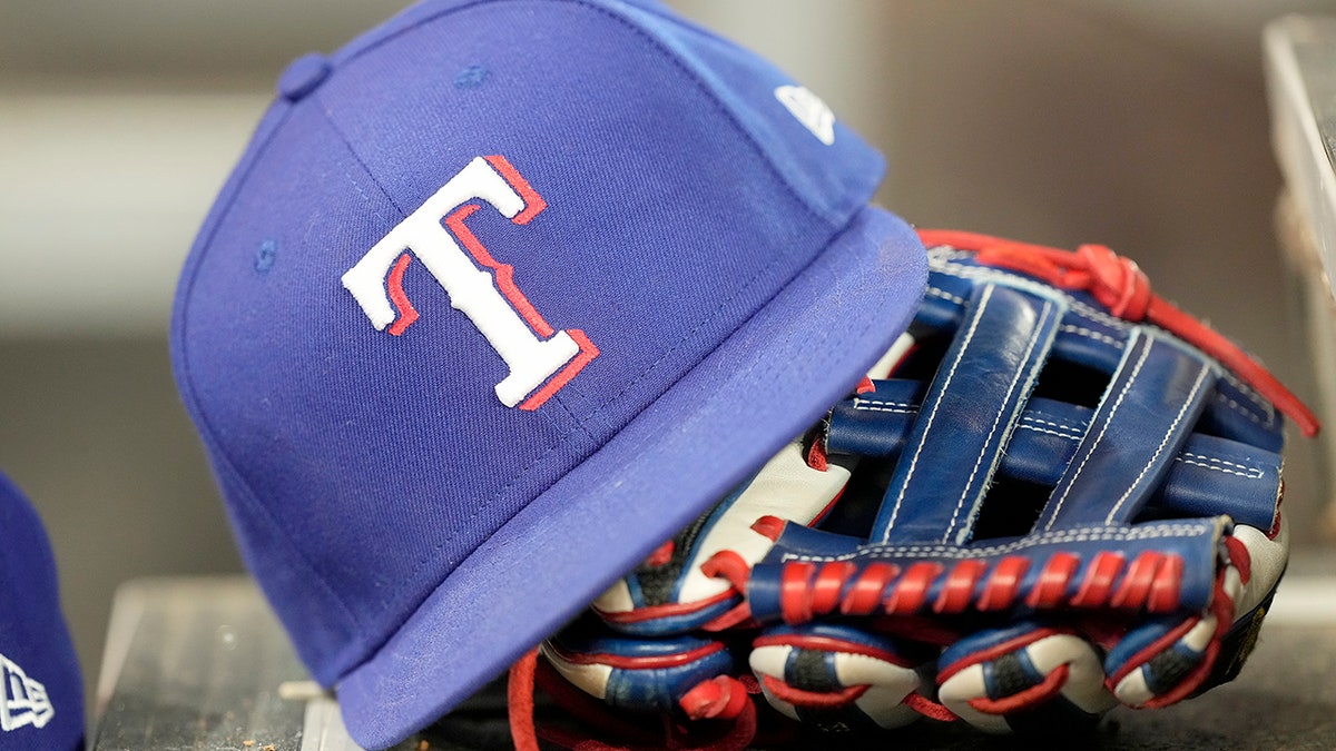 Texas Rangers hat and glove in dugout 4
