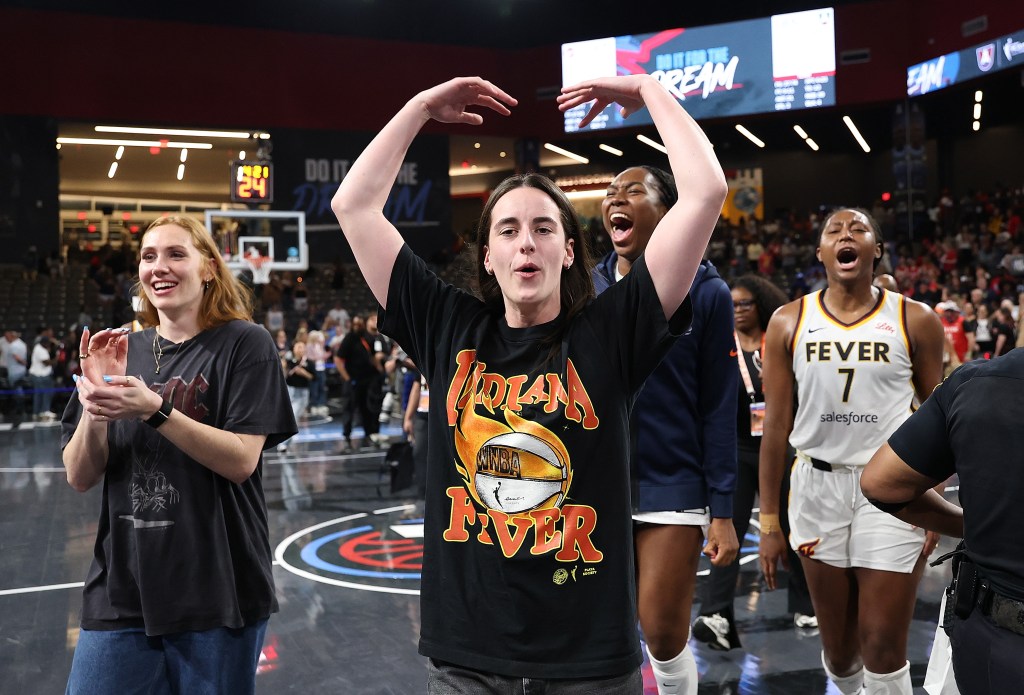 Caitlin Clark celebrates Fever's Game 3 win from the bench