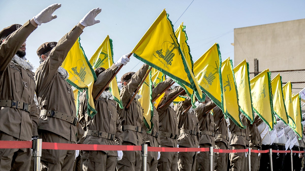Hezbollah supporters with yellow flags at a funeral in south Lebanon