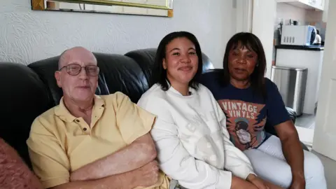 Teen using a landline-style alarm clock on a bedside table