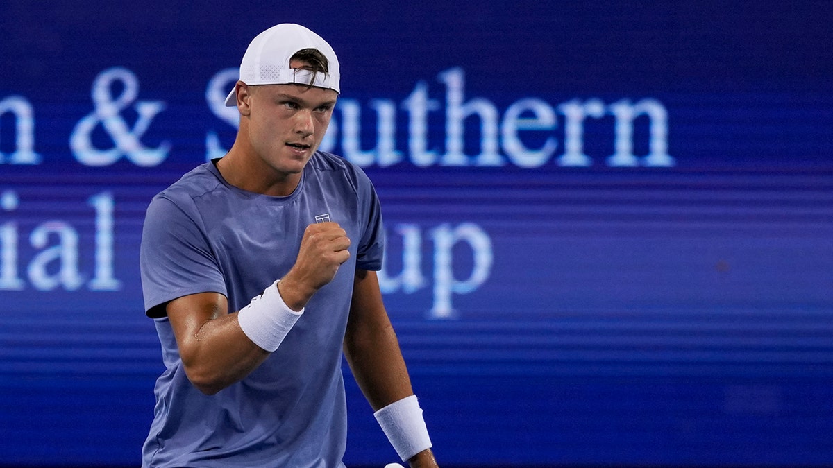 Holger Rune returns a shot