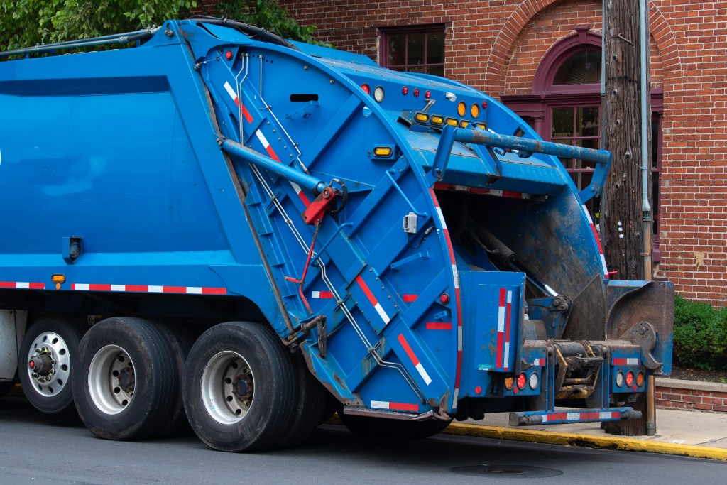 Garbage truck collecting trash