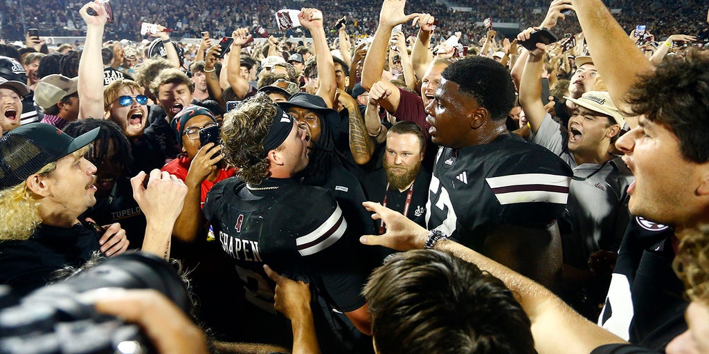 Mississippi State fans celebrate on the field after the win