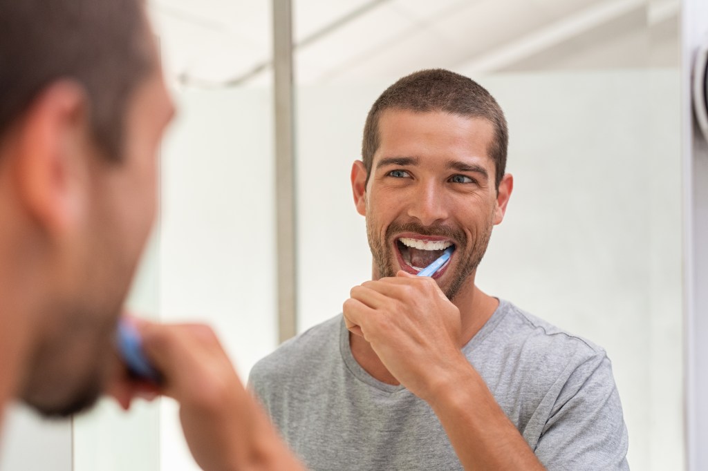 Man brushing his teeth in the bathroom