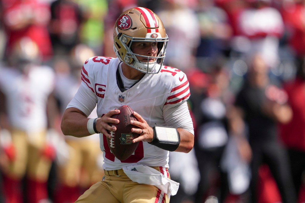 Purdy looks to throw during the first half against the Seahawks