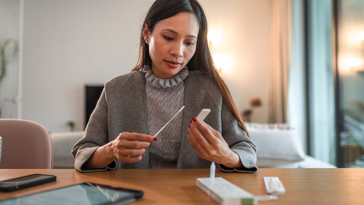 Woman taking at-home COVID-19 test