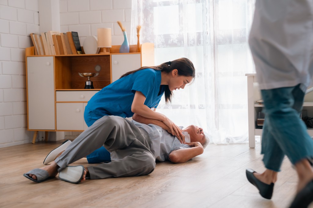 caregiver supporting an elderly patient
