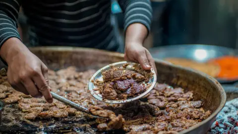 People at a Lucknow market stall