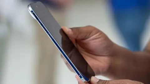 Person holding a slim iPhone model