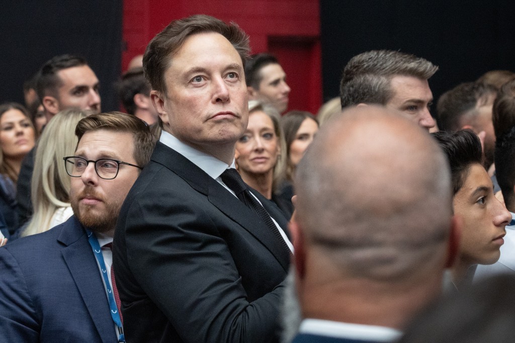 Elon Musk looks at the memorial