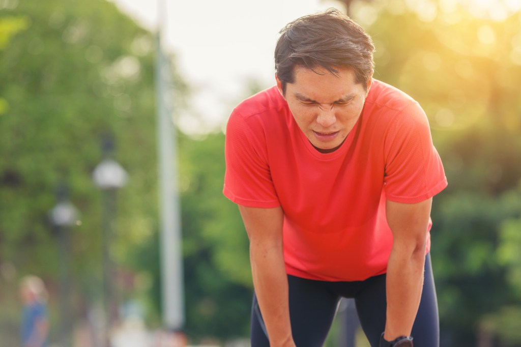 Tired man runner taking rest