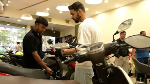 Bike showroom in Mumbai during tax cut rollout