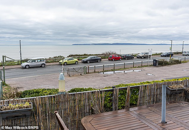 The concrete wall as seen from the street near the development site